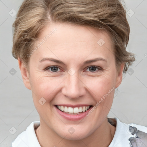 Joyful white young-adult female with short  brown hair and grey eyes