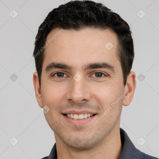 Joyful white young-adult male with short  black hair and brown eyes