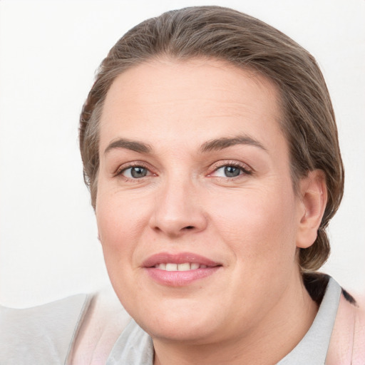 Joyful white young-adult female with medium  brown hair and grey eyes