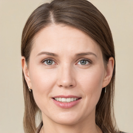 Joyful white young-adult female with long  brown hair and grey eyes