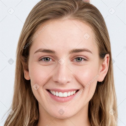 Joyful white young-adult female with long  brown hair and blue eyes