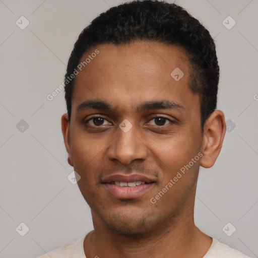 Joyful black young-adult male with short  black hair and brown eyes