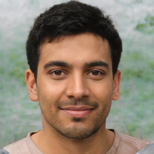 Joyful latino young-adult male with short  brown hair and brown eyes