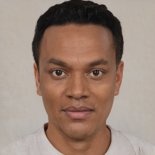 Joyful black young-adult male with short  black hair and brown eyes