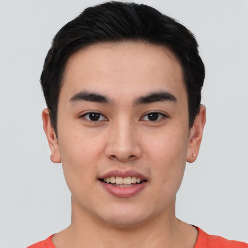 Joyful asian young-adult male with short  brown hair and brown eyes