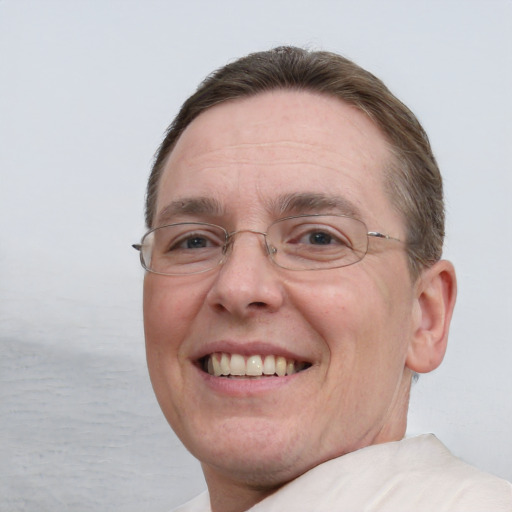 Joyful white adult male with short  brown hair and blue eyes