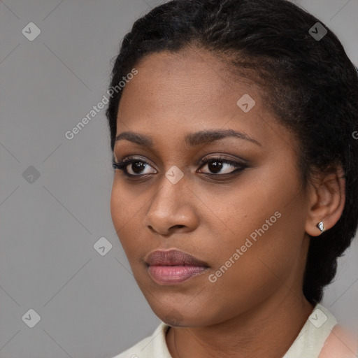 Joyful black young-adult female with short  black hair and brown eyes