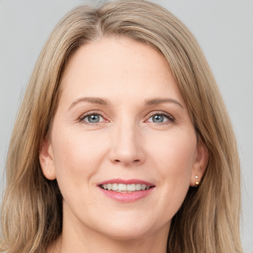 Joyful white young-adult female with long  brown hair and grey eyes