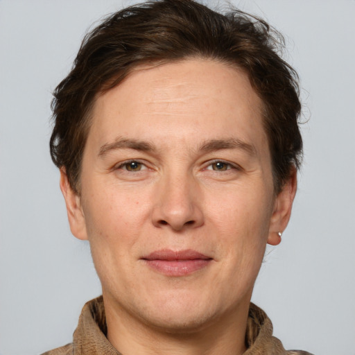 Joyful white adult male with short  brown hair and grey eyes