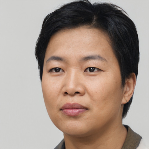 Joyful asian adult female with short  black hair and brown eyes