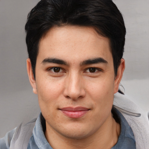 Joyful asian young-adult male with short  brown hair and brown eyes