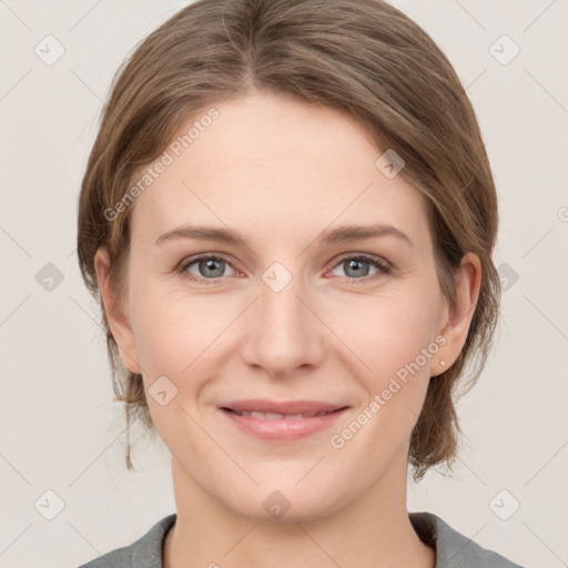 Joyful white young-adult female with medium  brown hair and grey eyes