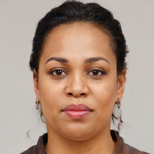 Joyful black young-adult female with medium  brown hair and brown eyes