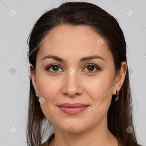 Joyful white young-adult female with long  brown hair and brown eyes