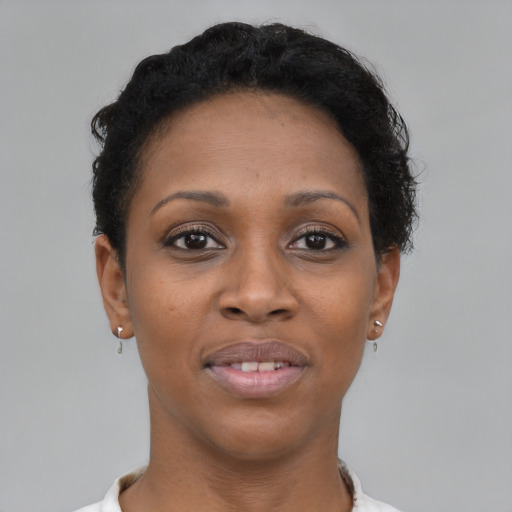 Joyful black young-adult female with short  brown hair and brown eyes
