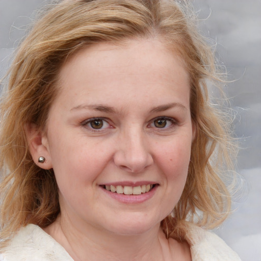 Joyful white young-adult female with medium  brown hair and blue eyes