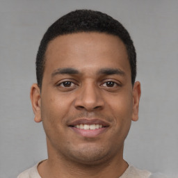 Joyful latino young-adult male with short  brown hair and brown eyes