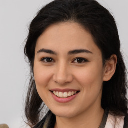 Joyful latino young-adult female with medium  brown hair and brown eyes