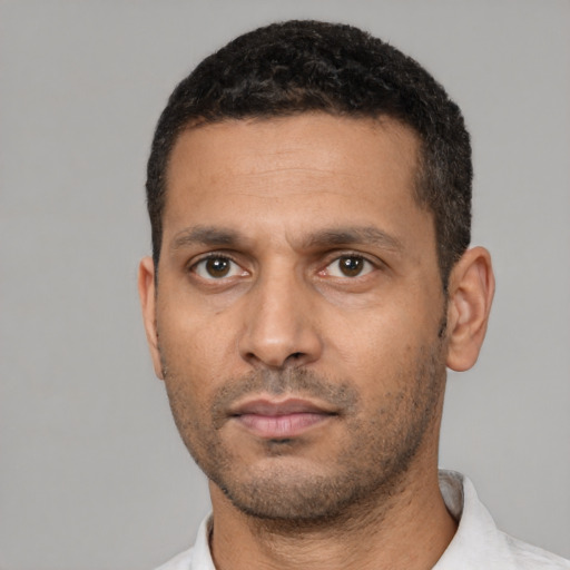 Neutral latino young-adult male with short  black hair and brown eyes