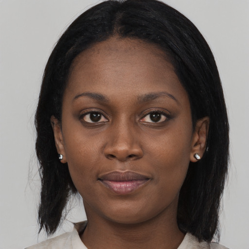 Joyful black young-adult female with medium  black hair and brown eyes