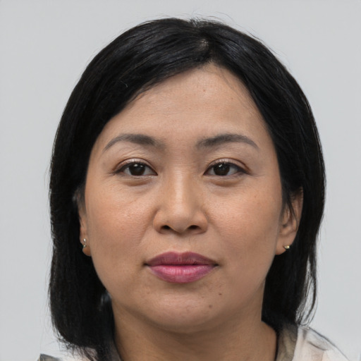 Joyful asian adult female with medium  black hair and brown eyes