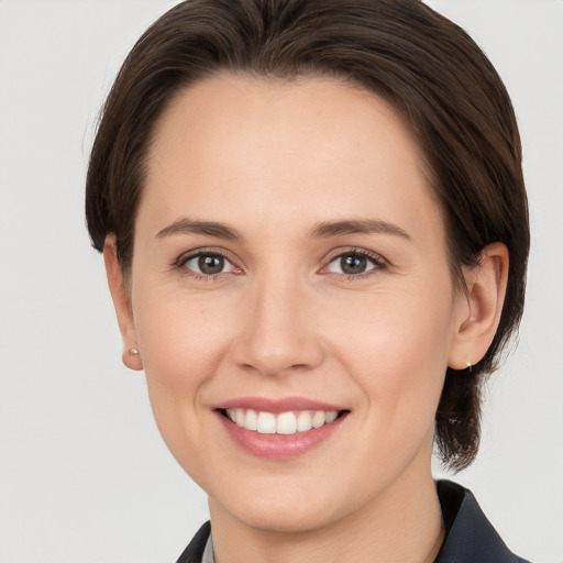 Joyful white young-adult female with medium  brown hair and brown eyes