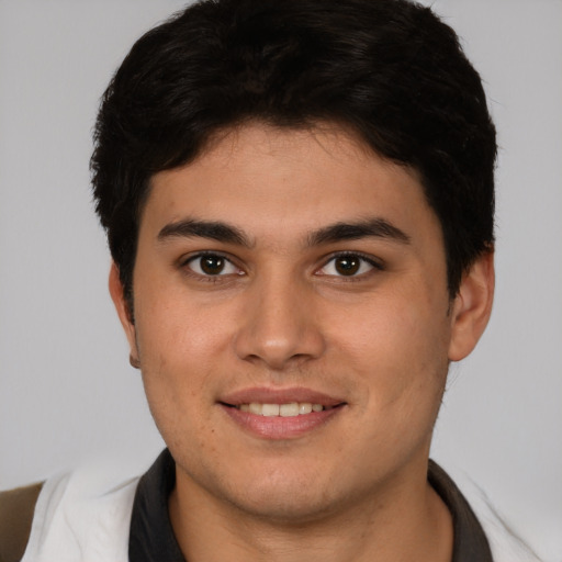 Joyful latino young-adult male with short  brown hair and brown eyes