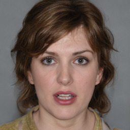 Joyful white young-adult female with medium  brown hair and blue eyes