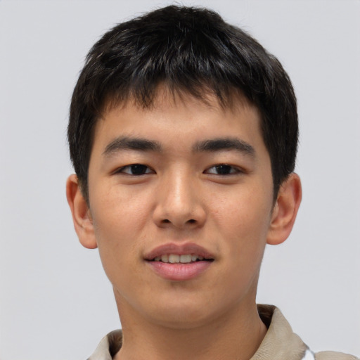 Joyful asian young-adult male with short  brown hair and brown eyes