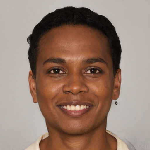 Joyful black young-adult male with short  black hair and brown eyes