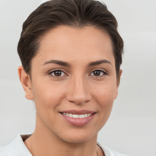 Joyful white young-adult female with short  brown hair and brown eyes