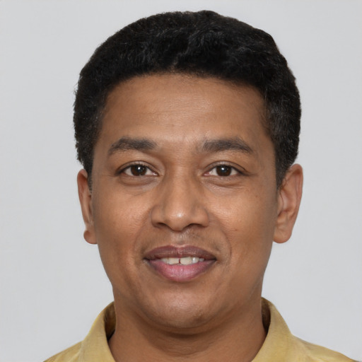 Joyful latino adult male with short  black hair and brown eyes