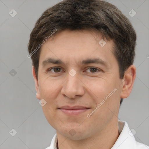 Joyful white adult male with short  brown hair and brown eyes