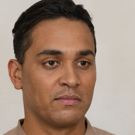 Neutral latino young-adult male with short  brown hair and brown eyes