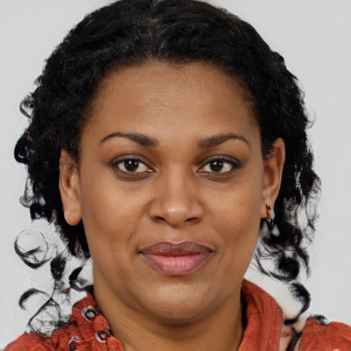 Joyful black adult female with medium  brown hair and brown eyes