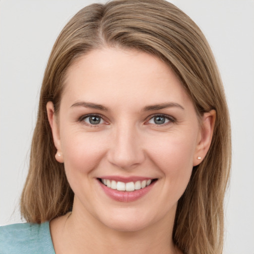 Joyful white young-adult female with long  brown hair and grey eyes