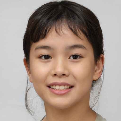 Joyful asian child female with medium  brown hair and brown eyes