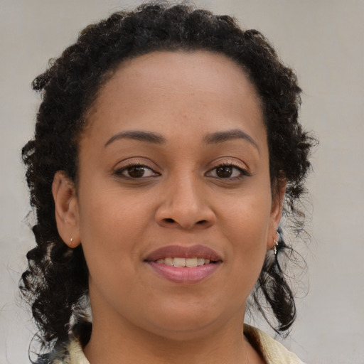 Joyful black young-adult female with medium  brown hair and brown eyes