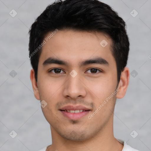 Joyful white young-adult male with short  black hair and brown eyes