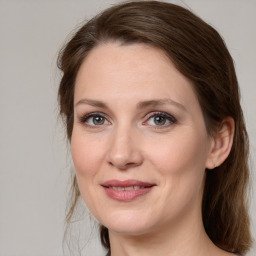 Joyful white adult female with medium  brown hair and grey eyes