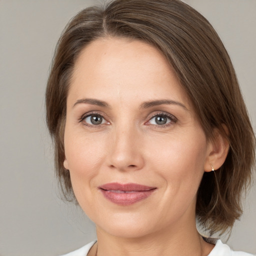 Joyful white adult female with medium  brown hair and brown eyes