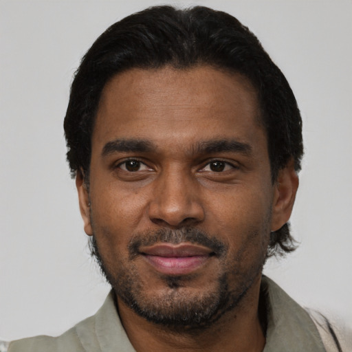Joyful black young-adult male with short  black hair and brown eyes