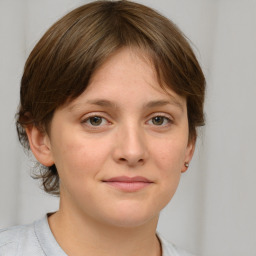 Joyful white young-adult female with medium  brown hair and grey eyes