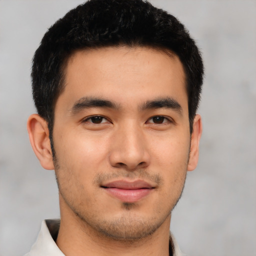 Joyful asian young-adult male with short  brown hair and brown eyes
