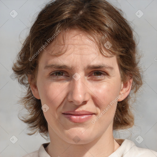 Joyful white adult female with medium  brown hair and blue eyes