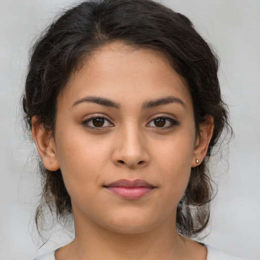 Joyful latino young-adult female with medium  brown hair and brown eyes