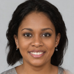 Joyful black young-adult female with medium  brown hair and brown eyes