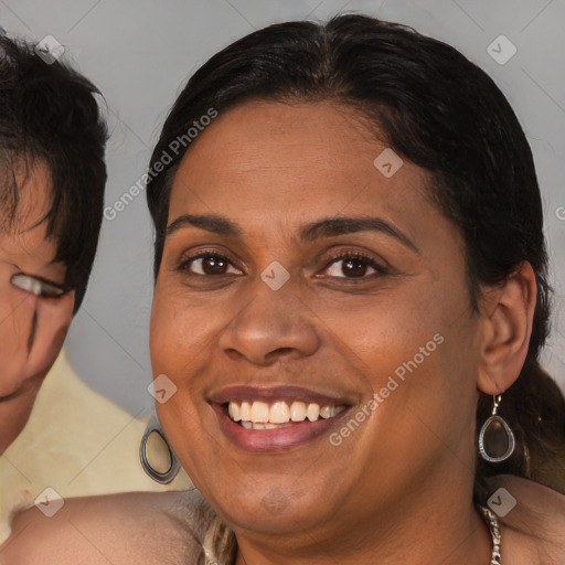 Joyful black adult female with medium  brown hair and brown eyes