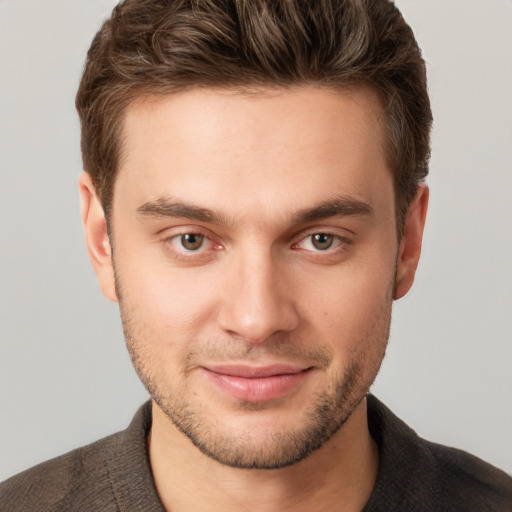 Joyful white young-adult male with short  brown hair and brown eyes