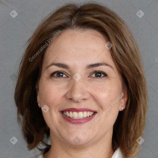 Joyful white adult female with medium  brown hair and grey eyes